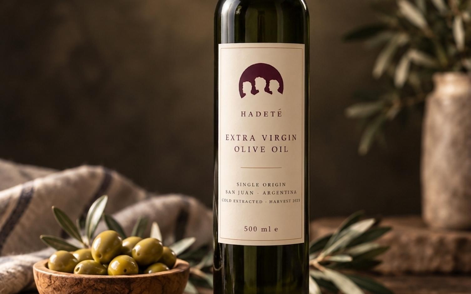 Hadeté extra virgin olive oil on a table with olives